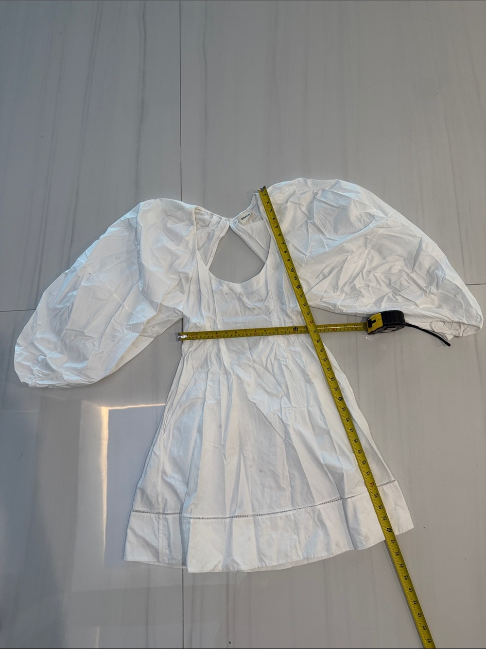 KHAITE White Puff-Sleeve Mini dress with open back and beautiful stitching.